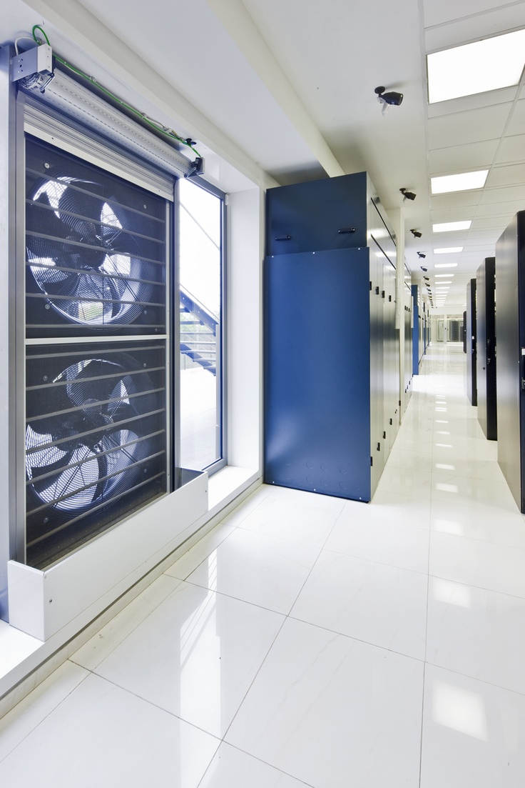 Server room cooling system in Kenya showing air conditioning units and industrial ventilation fans working together