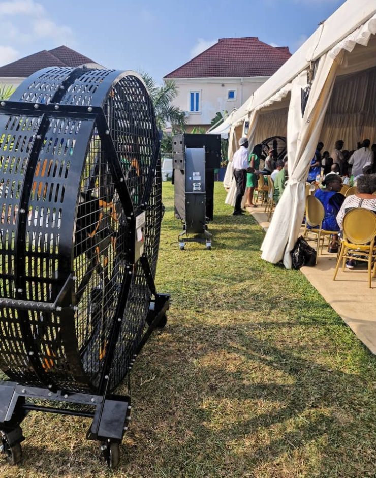 Heavy-duty portable industrial ventilation fan providing cooling and air circulation at an outdoor event tent in Kenya