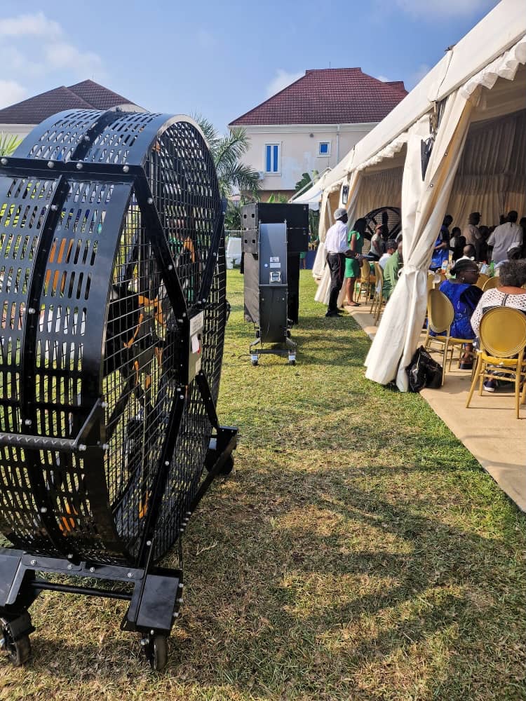 Heavy-duty portable industrial ventilation fan providing cooling and air circulation at an outdoor event tent in Kenya