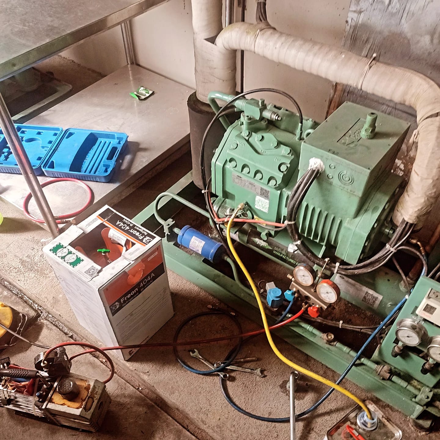 Technician performing preventive maintenance on a commercial cold room refrigeration system in Kenya