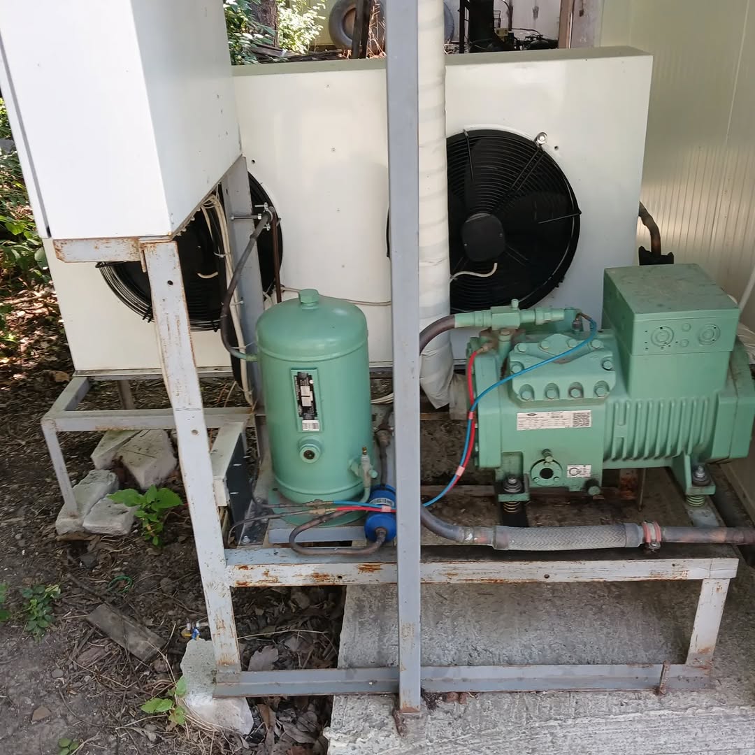 Outdoor condensing unit undergoing annual maintenance