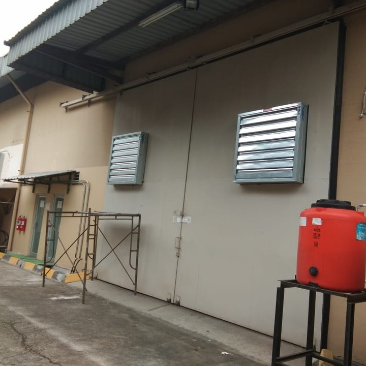 Louvered exhaust vents mounted on a warehouse exterior wall