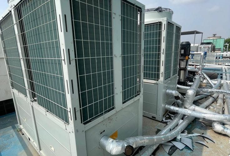 HVAC technician performing preventive maintenance on a VRF system and split air conditioner in Kenya by The Cold Room Kahuna