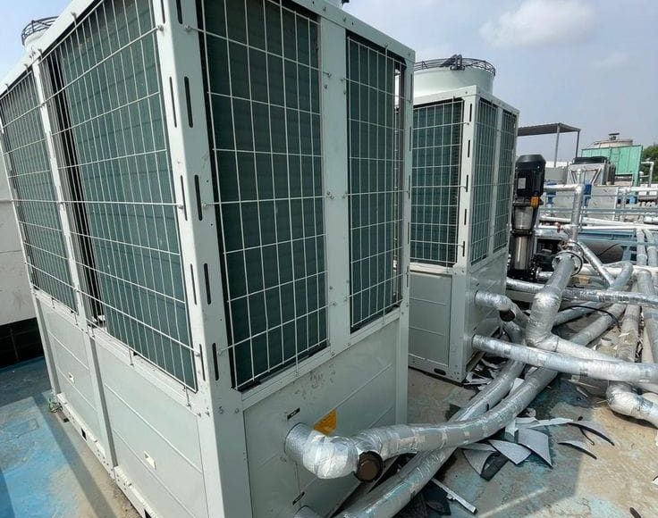 HVAC technician performing preventive maintenance on a VRF system and split air conditioner in Kenya by The Cold Room Kahuna