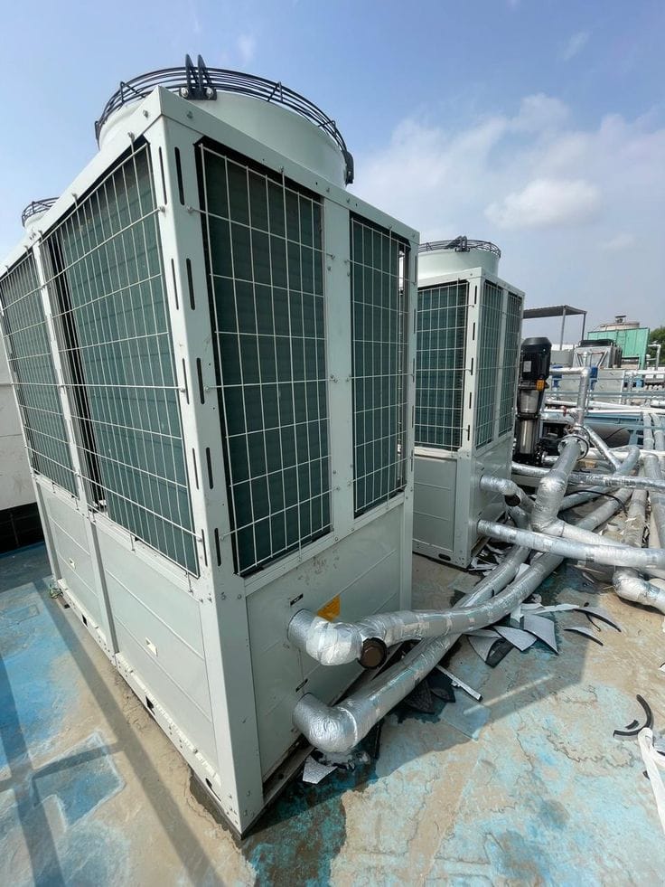 HVAC technician performing preventive maintenance on a VRF system and split air conditioner in Kenya by The Cold Room Kahuna